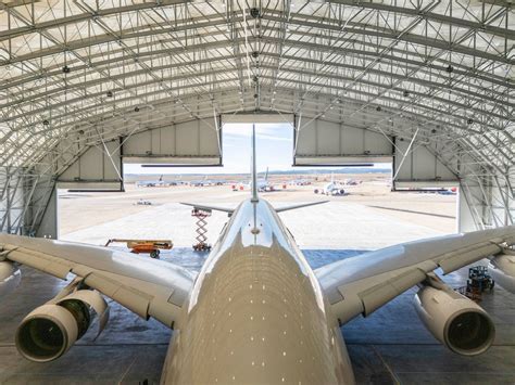 engineers inspecting Airbus A380 engines inside Teruel Airport maintenance facility