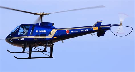 Enstrom F28 light utility helicopter on ramp