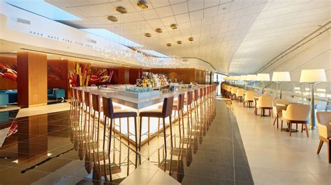 Etihad business lounge Abu Dhabi bright interior seating bar area