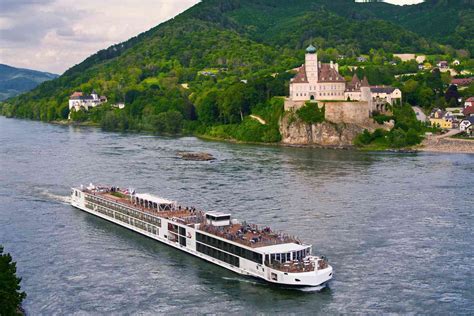 European river cruise ship sailing past historic castles and vineyards