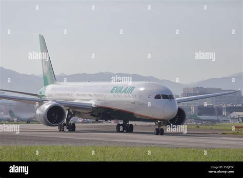 EVA Air Boeing 787 on runway with Taipei skyline in background