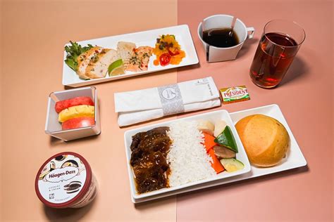 EVA Air economy class meal with printed menu metal cutlery and Asian cuisine
