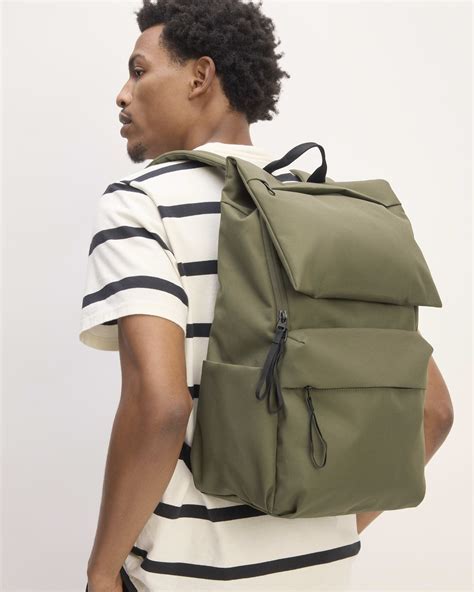 Everlane ReNew Transit backpack on tray table during flight