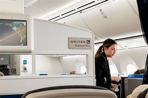 executive business traveler boarding United Airlines premium cabin with corporate travel significance