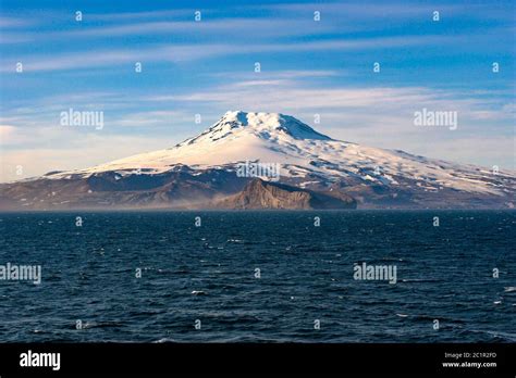 Expedition team at Jan Mayen with Beerenberg volcano in background