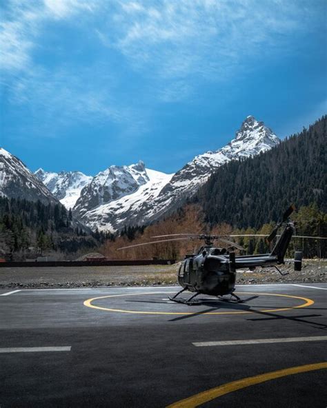 experienced helicopter pilot performing a precision landing on mountain helipad