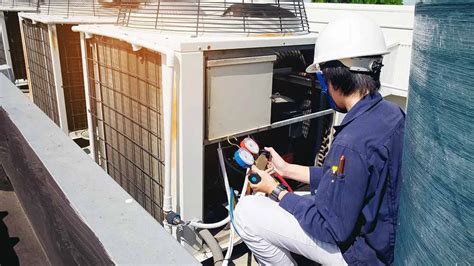 experienced maintenance tech inspecting hvac unit at housing complex in new iberia la