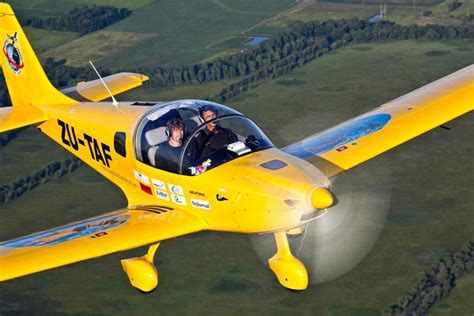 experienced pilot flying LSA during golden hour over rural fields