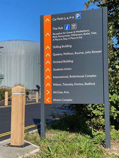 exterior signage of Wilmington Airport with travelers walking toward entrance