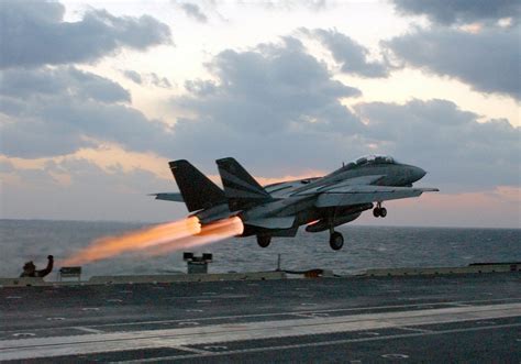 F-14 Tomcat launching from aircraft carrier with wings extended