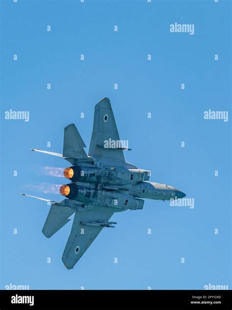 F-15 Eagle climbing vertically with afterburners at high altitude