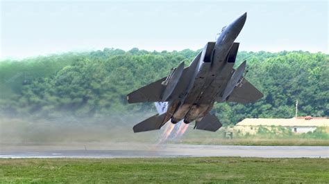 F-15 Eagle full afterburner vertical climb blue sky contrails