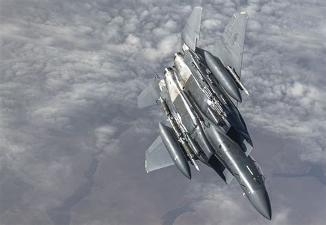 f-15 eagle returning to base after combat sortie with visible missile racks