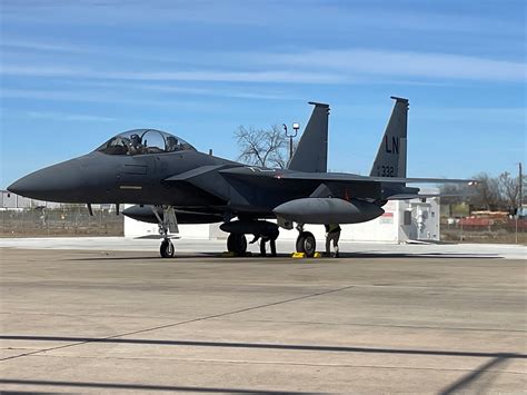 F-15E Strike Eagle in flight over Gulf Coast controlling XQ-58A Valkyrie in autonomous maneuver test