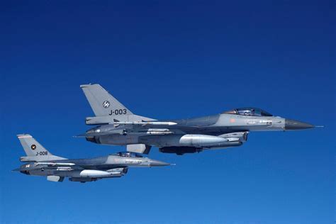 f-16 and f-22 flying in formation
