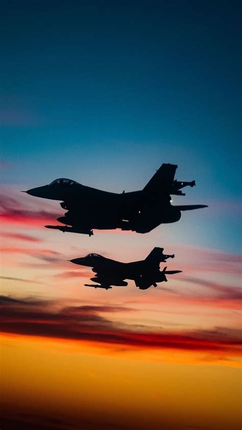 f-16 viper climbing vertically with afterburner trail at sunset
