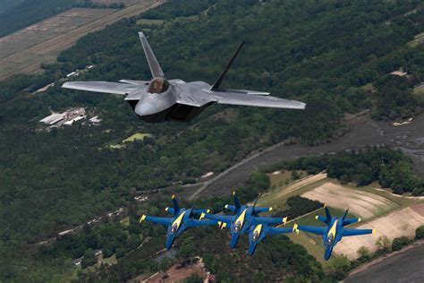 F-22 and Blue Angels performing a joint demo at the Blue Angels Homecoming