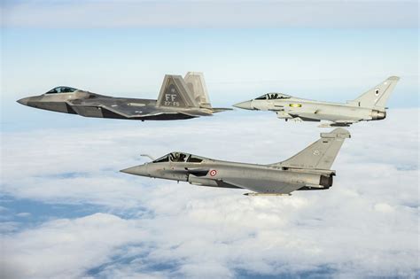 F-22 Raptor and Eurofighter Typhoon in flight showcasing contrasting designs