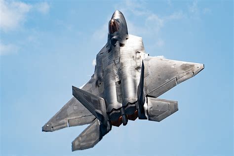 F-22 Raptor breaking formation after refueling maneuver near Virginia coastline