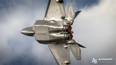 f-22 raptor flight demonstration over alaska with snow capped mountains
