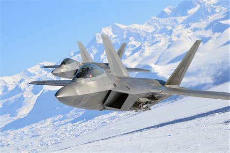 F-22 Raptor flying over Alaska mountains near Elmendorf AFB