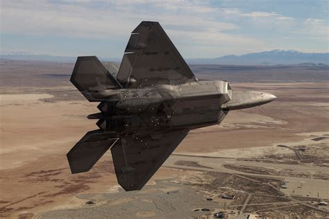 F-22 Raptor preparing for test flight at Edwards Air Force Base with flight crew nearby