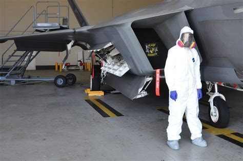 f-22 undergoing maintenance and stealth coating application
