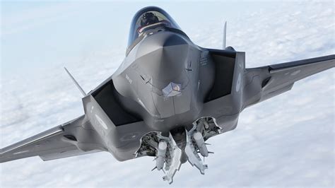 F-35A stopping on a snow-covered airstrip using deployed drag chute