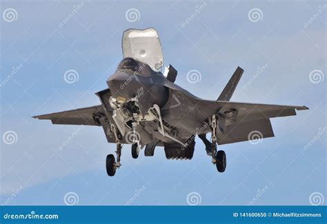 F-35B hovering over USS Bataan during vertical landing demonstration