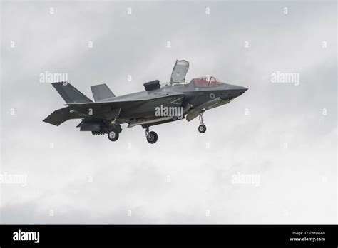 F-35B Lightning II hovering over flight deck at sunset