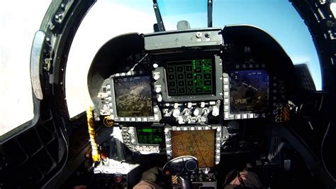 F/A-18 Hornet cockpit view with pilot managing flight controls