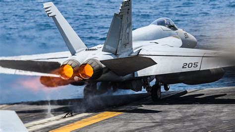 f/a-18 launching from aircraft carrier