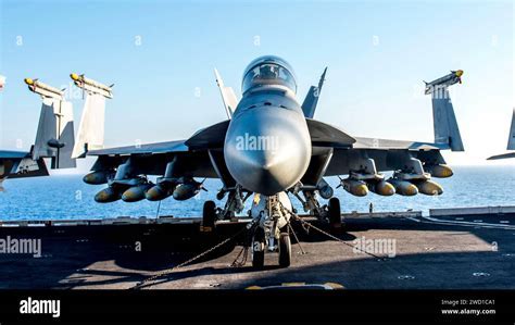 F/A-18 Super Hornet loaded with laser-guided bombs on forward airstrip