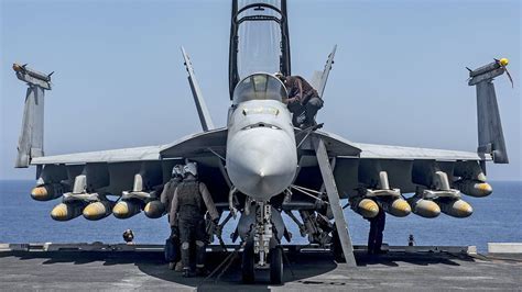 F/A-18 with full combat load, including JDAMs, air-to-air missiles, and external fuel tanks