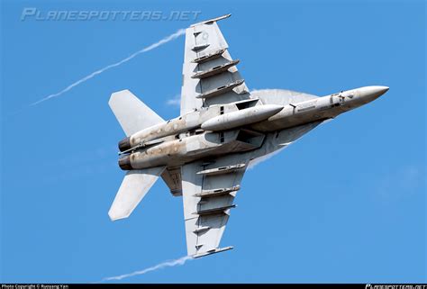F/A-18F Super Hornet twin-engine fighter banking during US Navy flight operations