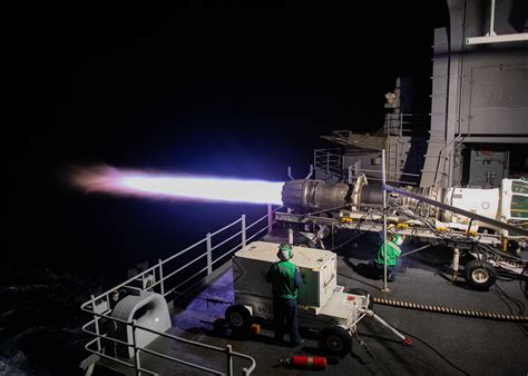 F414 engine being installed in a Super Hornet at an aircraft carrier