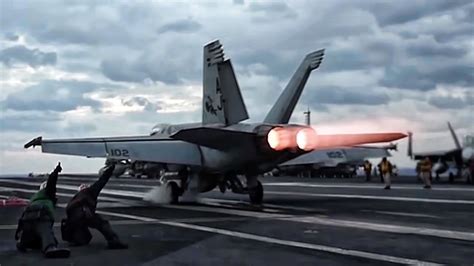fa-18 super hornet launching from aircraft carrier during night operation