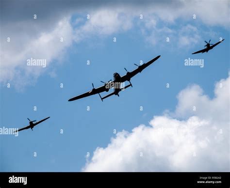 families and veterans watching lancaster bomber flypast