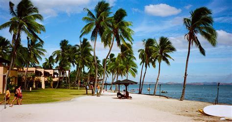 family enjoying the beach in Denarau during Fiji Airways layover stop