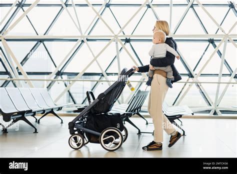 family with baby stroller boarding air france plane