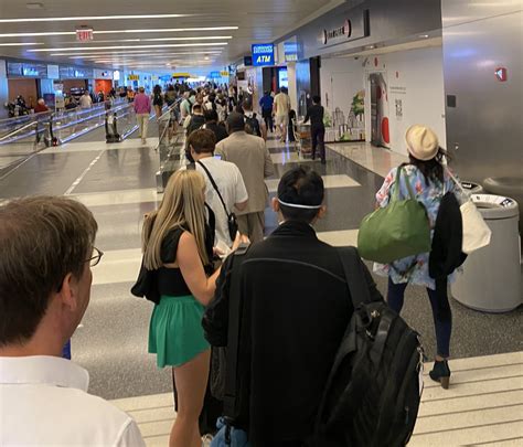 family with young children boarding a daytime flight at JFK Airport