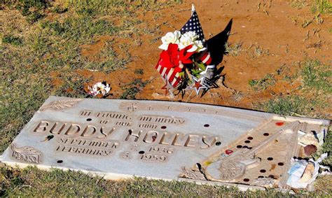 fans placing memorabilia at Buddy Holly crash memorial pole