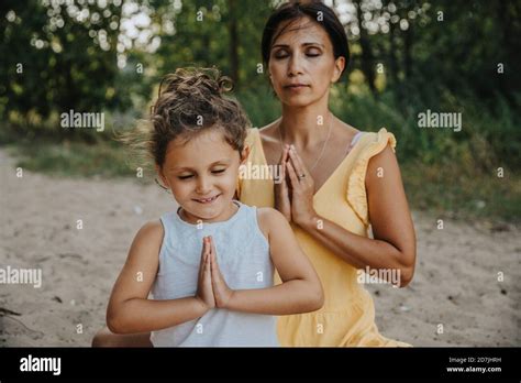 father and adult daughter meditating at a Dharamshala retreat