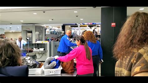 FBI agents near airport security checkpoint at JFK Airport