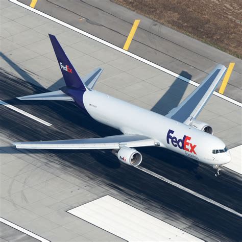 FedEx Boeing 767 freighter loading cargo at night ramp operations