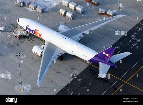 FedEx Boeing 777F cargo aircraft at airport with pilot crew