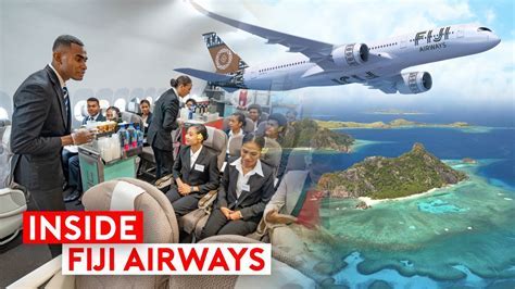 Fiji Airways crew member offering drink service to passengers