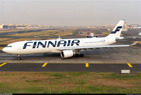finnair a330-300 at gate with mount rainier in background