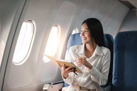 first time business class traveler filming luxury airline suite on smartphone