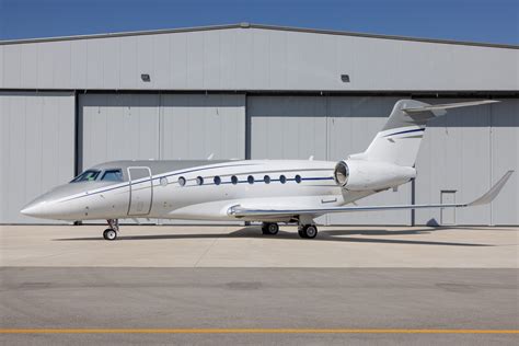 Fleet maintenance crew servicing a Gulfstream G280 in fractional operations hangar